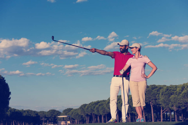 portrait of happy young couple on golf course - Zdjęcie, obraz