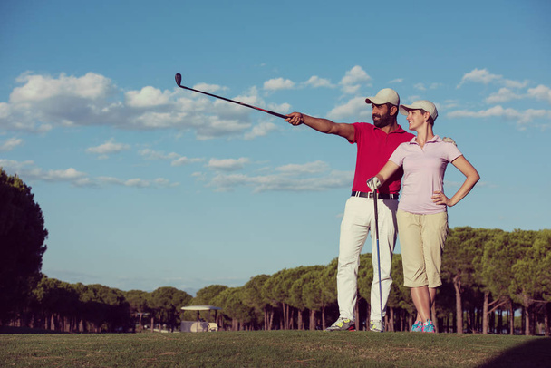 portrait of happy young couple on golf course - Valokuva, kuva
