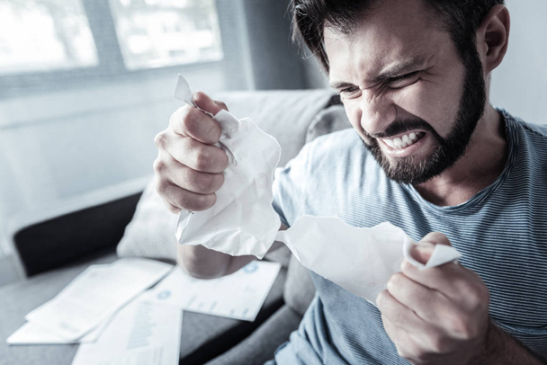 Stressful mad man tearing paper - Photo, image