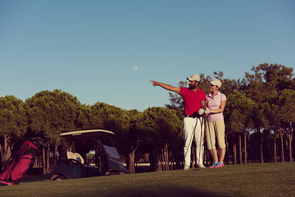 portrait of happy young couple on golf course - Fotografie, Obrázek