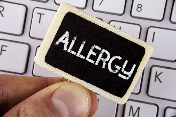Writing note showing  Allergy. Business photo showcasing damages in immunity due to hypersensitivity get it diagnised written on Wood Piece holding by man on the Laptop. - Photo, Image
