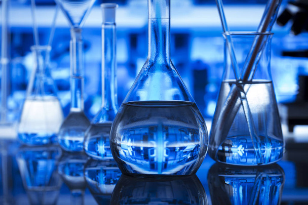 Science concept. Modern laboratory interior. Laboratory glassware. Chemical experiment. Blue background. - Φωτογραφία, εικόνα