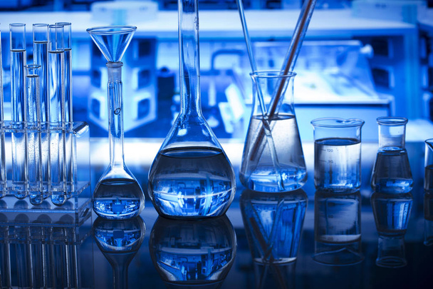 Science concept. Modern laboratory interior. Laboratory glassware. Chemical experiment. Blue background. - Photo, Image