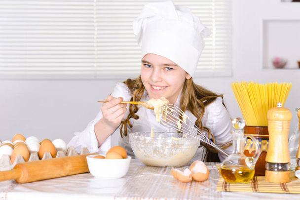 Cute girl cooking  in the kitchen  at home - Foto, Imagen