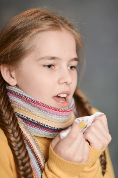 Portrait of sick  girl wearing scarf  - Fotó, kép