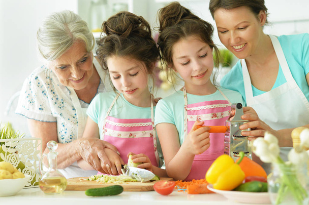 mother and daughters cooking together - Photo, image