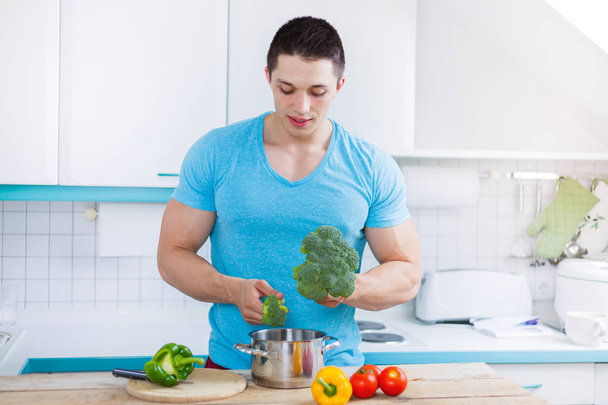 Young man cooking healthy preparing meal vegetables in the kitch - Φωτογραφία, εικόνα