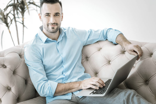 Charming male freelancer updating projects list - Photo, image