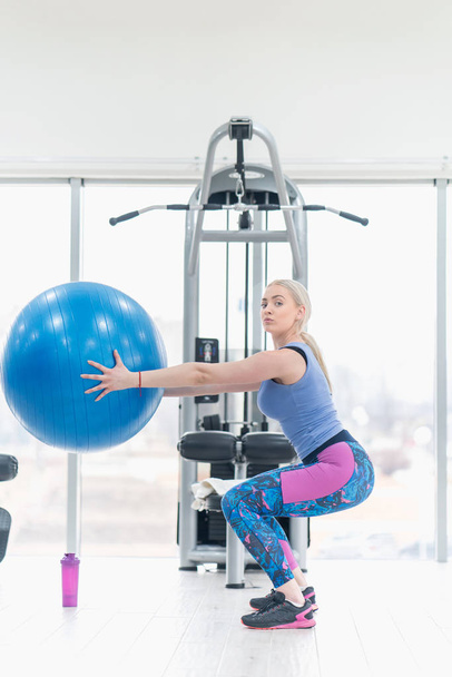 Young woman girl exercise workout in the gym using ball - Photo, Image