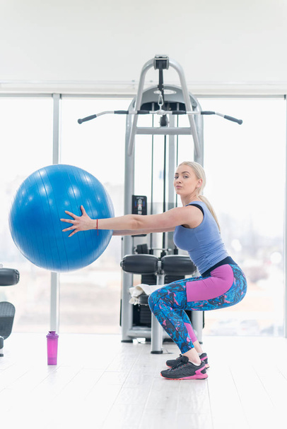 Young woman girl exercise workout in the gym using ball - Photo, image