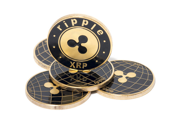 Shiny golden and black ripple coins over a white background. - Photo, Image