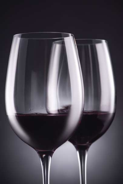 close-up shot of glasses of delicious red wine on black - Фото, зображення