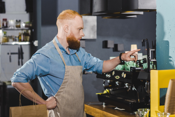 young male barista in apron taking order on digital tablet  - Photo, Image