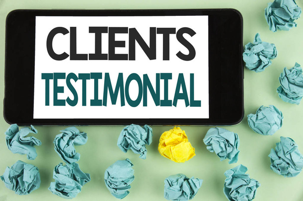 Conceptual hand writing showing Clients Testimonial. Business photo text Customers Personal Experiences Reviews Opinions Feedback written on Mobile Phone Screen on the plain background Paper Balls. - Photo, Image