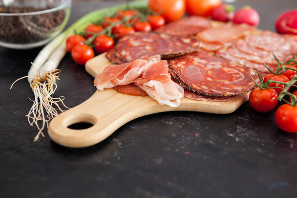 Close up on different delicious meat on wooden board - Fotó, kép