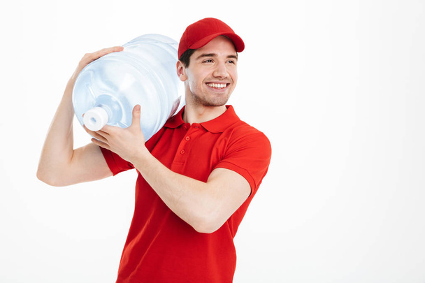 Image of content delivery courier in red t-shirt and cap carryin - Fotó, kép
