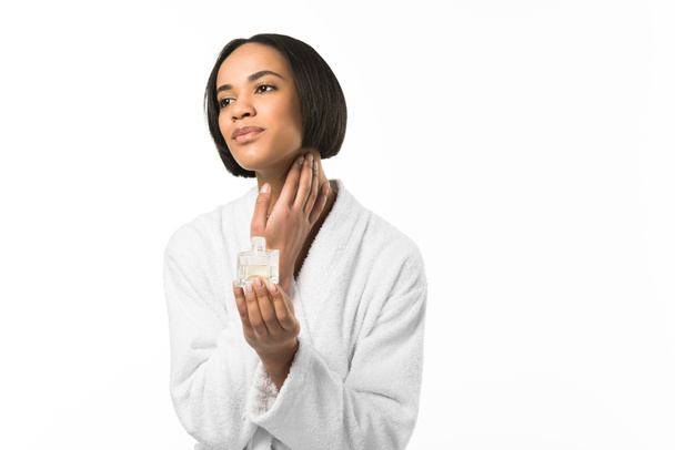 african american woman applying perfume on neck,  isolated on white - Фото, изображение