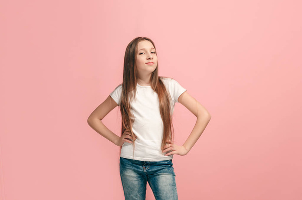The happy teen girl standing and smiling against pink background. - Φωτογραφία, εικόνα