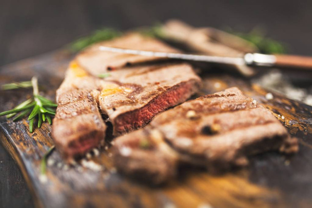 Grilled steak on wooden cutting board - Φωτογραφία, εικόνα