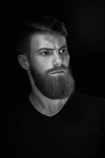 Black and white portrait of young handsome bearded man - Фото, изображение