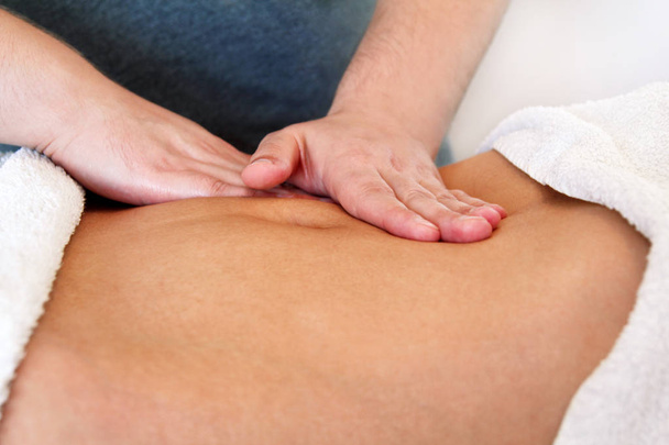 Close up of hands massaging female abdomen - Photo, Image