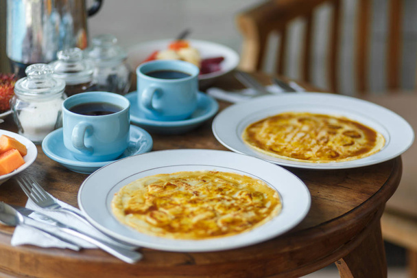 Balinesse breakfast on wooden table - Фото, зображення