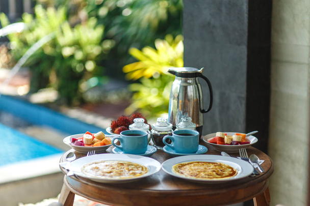 Balinesse breakfast on wooden table - Fotó, kép