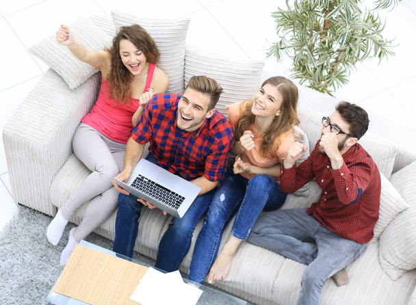 group of friends watching a video on a laptop and laughing - Foto, immagini