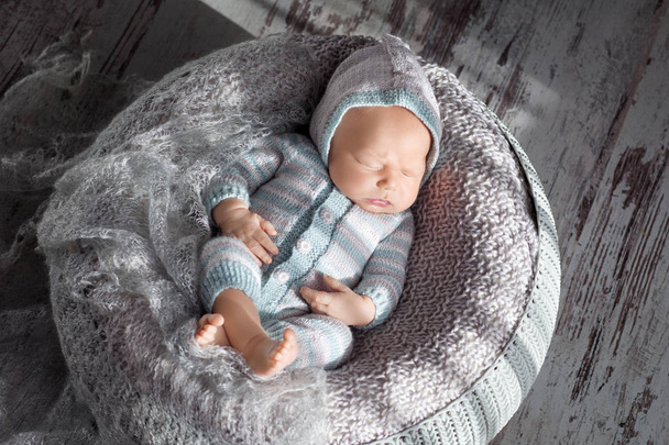Beautiful little newborn boy 20 days  sleeps in a basket. Portra - Фото, зображення