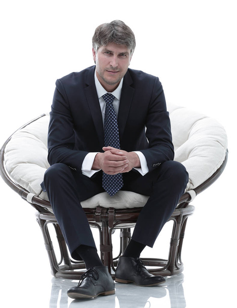 Tired business man sitting in a large comfortable chair - Foto, Imagem