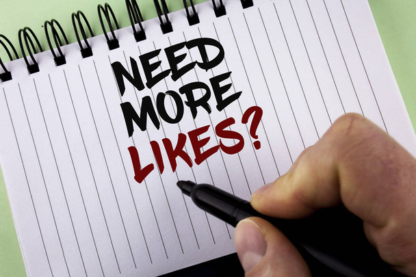 Text sign showing Need More Likes Question. Conceptual photo Improve reach Ads Marketing SEO Marketing Improve written by Man on Notepad holding Marker on the plain background. - Photo, Image