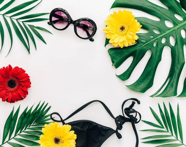 Flat lay summer composition. Creative concept with bikini and tropical flowers. Top view, copy space - Фото, изображение
