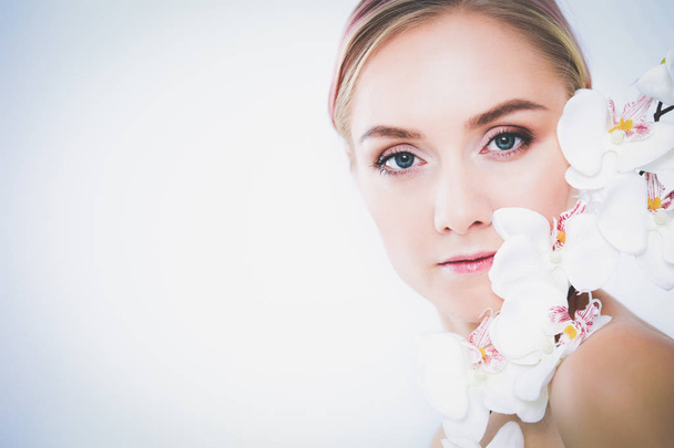 Young beauty woman with flower near face - Фото, изображение