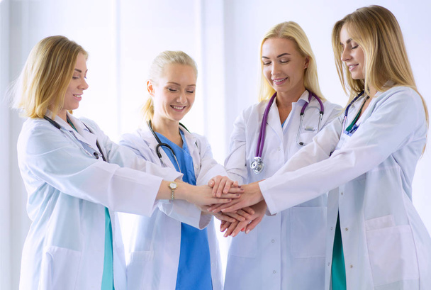 Doctors and nurses in a medical team stacking hands - Foto, Bild