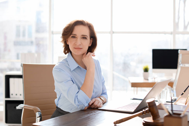 Female lawyer working at table in office - Foto, Bild