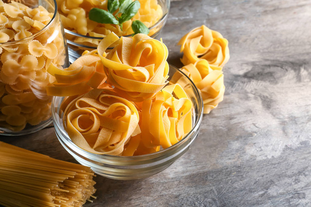 Different uncooked pasta on table - Photo, image