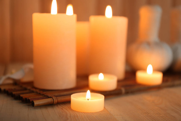 Burning candles on wooden background - Fotografie, Obrázek