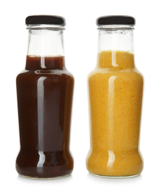 Bottles with tasty sauces on white background - Photo, Image