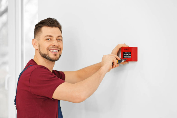 Electrician installing fire alarm system - Photo, Image