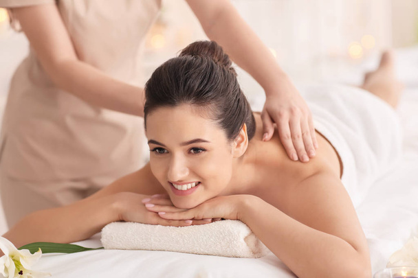 Young woman receiving massage in spa salon - Foto, immagini