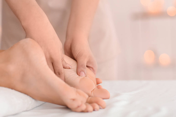 Молодая женщина получает массаж ног в спа-салоне, крупным планом
 - Фото, изображение