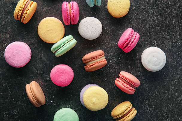 Colorful macarons on dark background, top view - Photo, Image