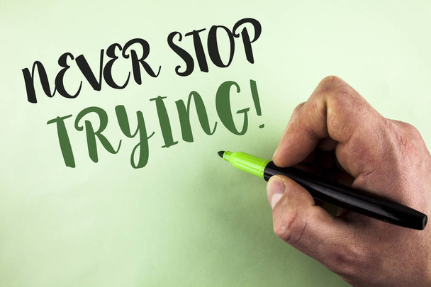 Text sign showing Never Stop Trying Motivational Call. Conceptual photo go on do not give up Self confidence written by Man holding Marker in Hand on plain background. - Photo, Image