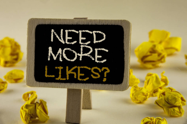 Text sign showing Need More Likes Question. Conceptual photo Improve reach Ads Marketing SEO Marketing Improve written on Wooden Notice Board on the plain background Yellow Paper Balls. - Photo, Image