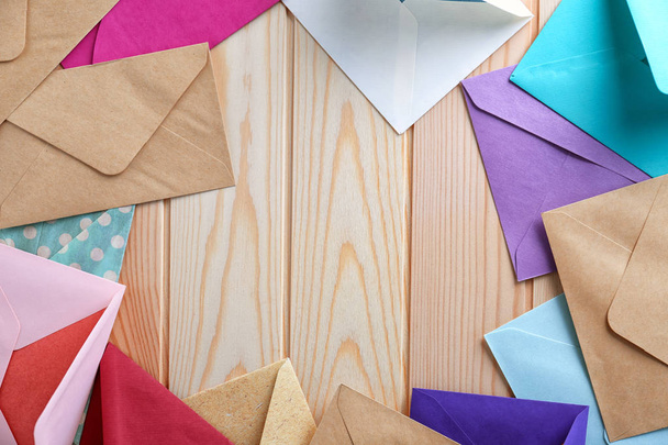 Colorful envelopes on wooden background, top view. Mail service - Photo, Image