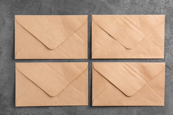 Brown envelopes on grey background, top view. Mail service - Photo, Image