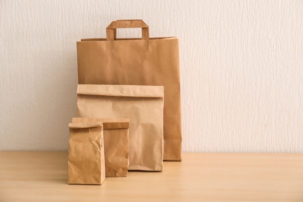 Different paper bags on light table. Food delivery service - Photo, Image
