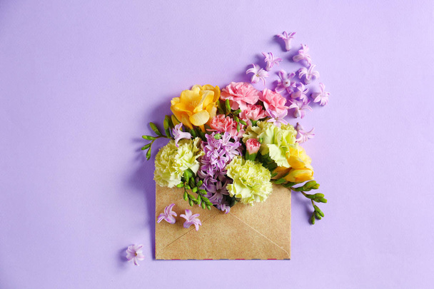 Open mail envelope with flowers on color background - Photo, Image