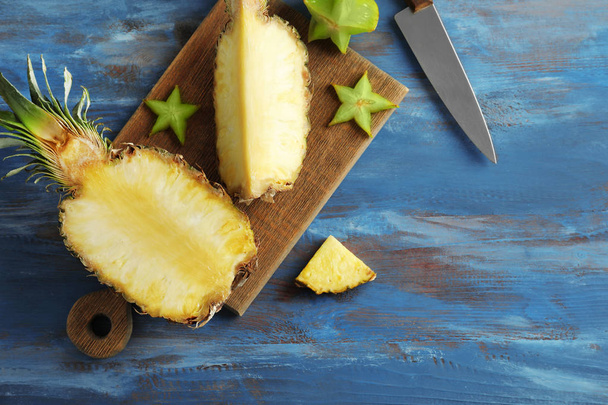 Ripe fresh pineapple on wooden table - 写真・画像