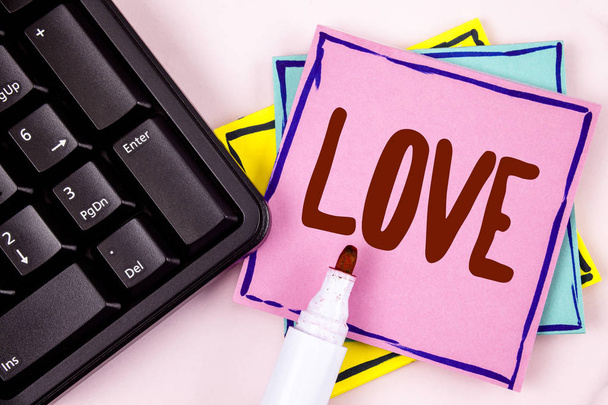 Text sign showing Love. Conceptual photo Intense feeling Deep affection Romantic Sexual attachment Relationship written on Pink Sticky Note paper on plain background Marker and Black Keyboard. - Photo, Image